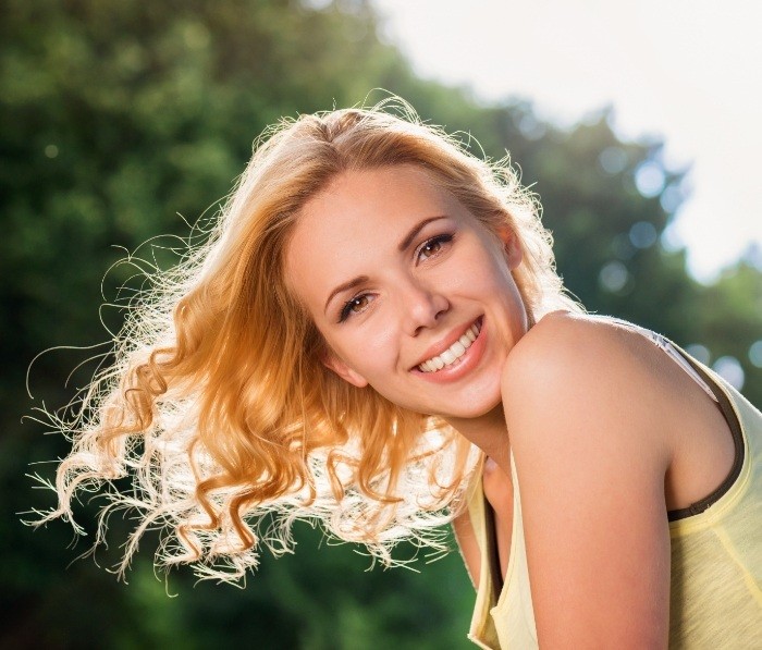 Blonde woman smiling outdoors