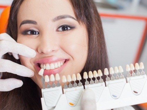 Young woman getting dental veneers from her cosmetic dentist