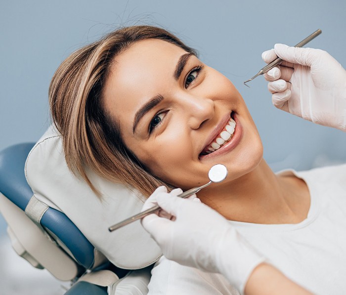 A smiling young woman about to receive dental care