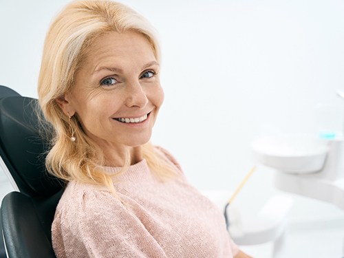 A smiling woman who just received a dental crown