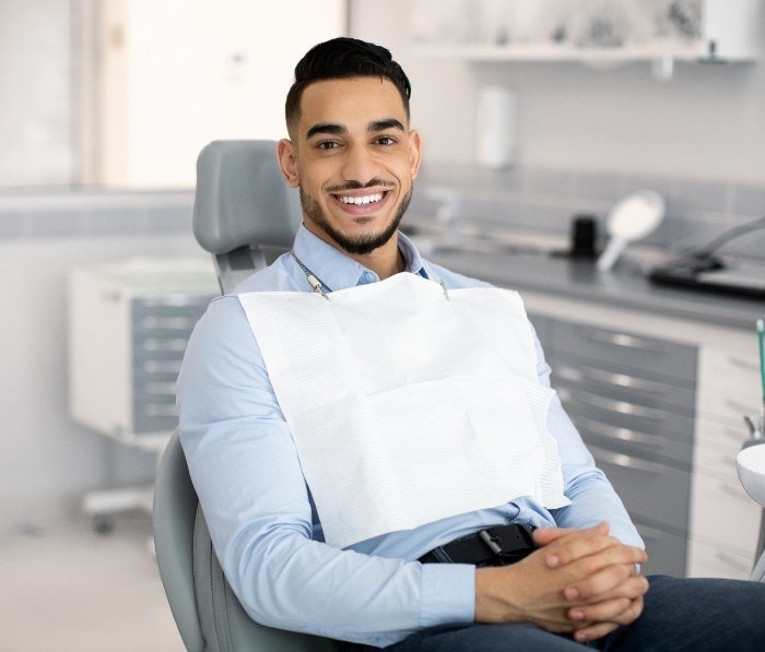 Smiling man sitting in dental chair
