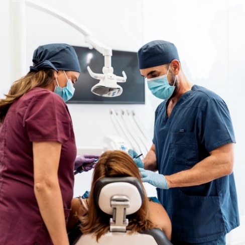 Dentist and assistant treating a dental patient