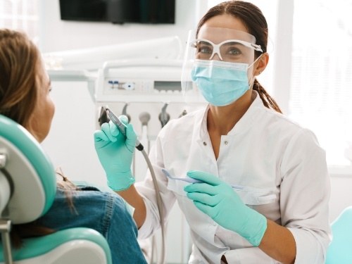 Dentist smiling while wearing face mask
