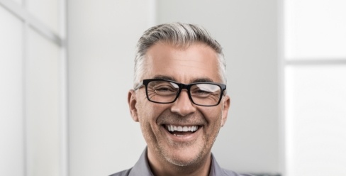 Smiling gary haired man with glasses