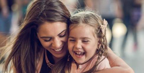 Mother laughing with her young daughter