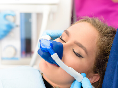 Dental patient wearing mask for nitrous oxide sedation dentistry